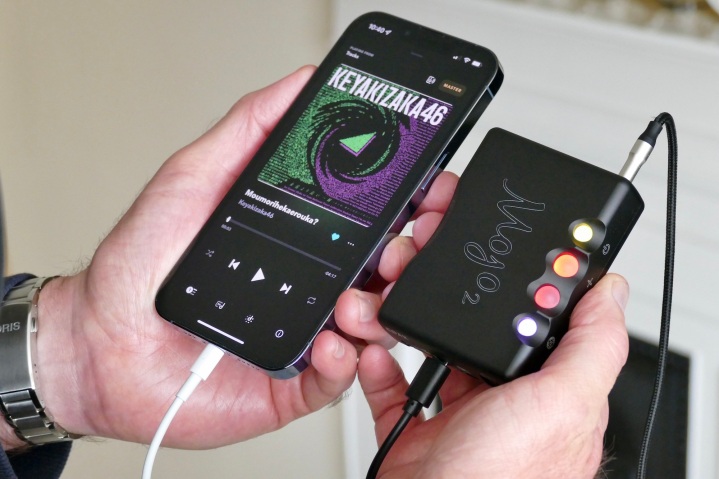 Chord Mojo 2 next to an iPhone 13 Pro.