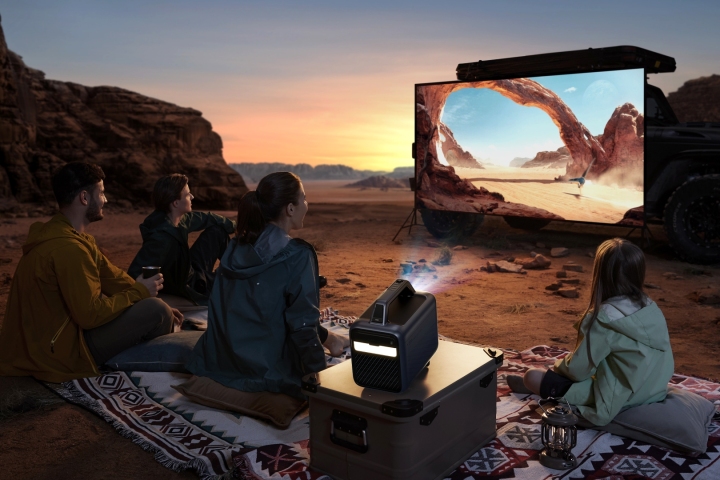 The Anker Nebula Mars 3 outdoor projector showing a movie on a screen in the desert.