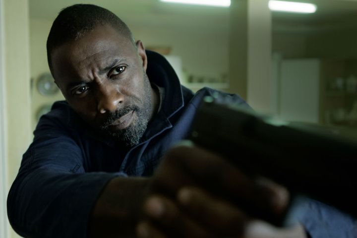 Idris Elba pointing a gun in The Take.