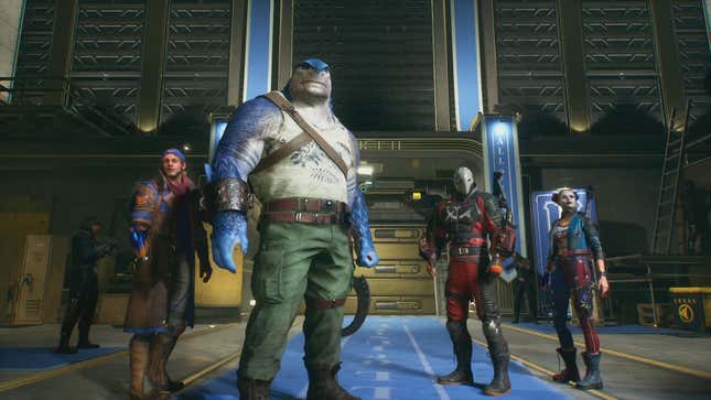 A screenshot shows the Suicide Squad standing together in the Hall of Justice. 