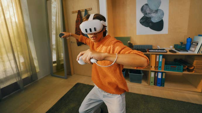 A person in an orange top and white trousers stands in a martial arts stance with two Meta Quest 3 controllers in their hands, and a headset strapped to their face.