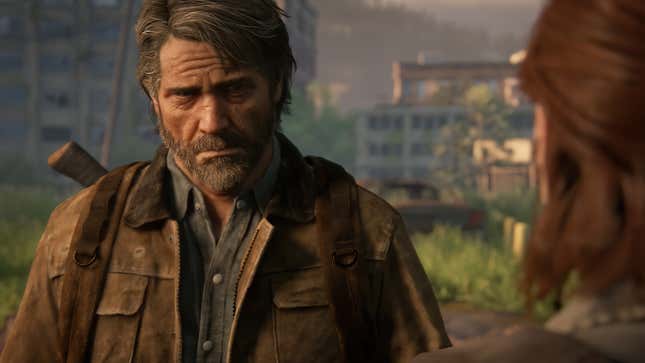 A screenshot shows a sad Joel looking at Ellie in The Last of Us Part II. 