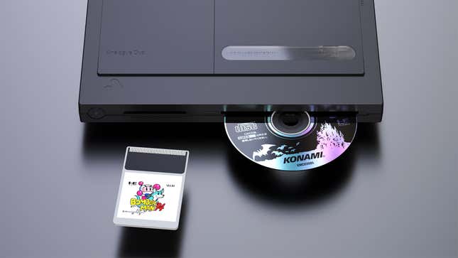 In a product shot a black Analogue Duo is shown alongside a Bomberman '94 HuCard and a Dracula X CD-ROM.