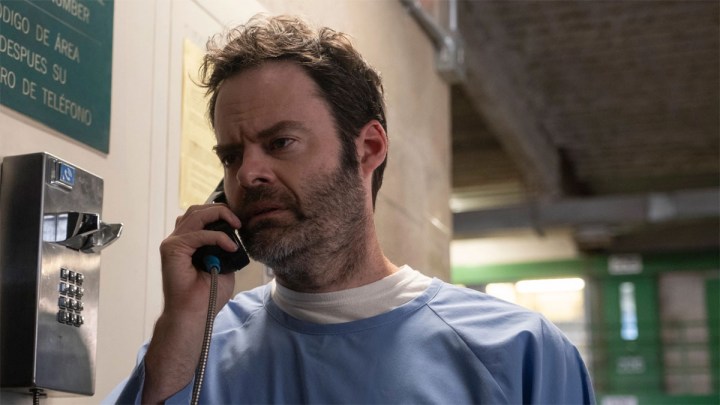 Bill Hader as Barry in a prison uniform on a payphone looking confused in HBO's Barry.