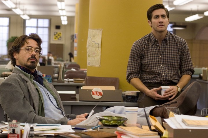 Robert Downey Jr. and Jake Gyllenhaal sit in an office together in Zodiac.
