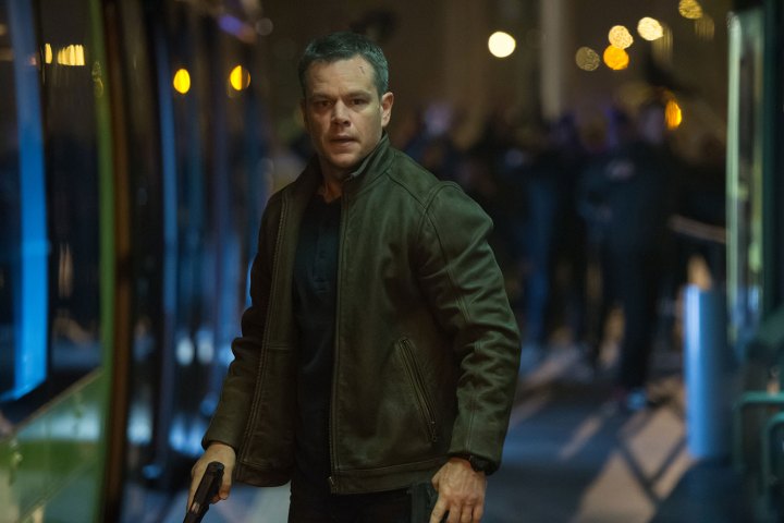 A man stands with a gun in Jason Bourne.